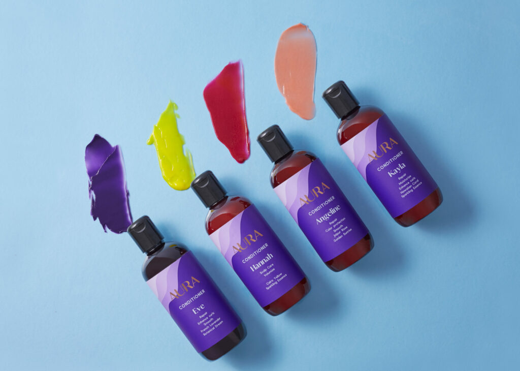 AURA Conditioner bottles with different pigment swatches above them