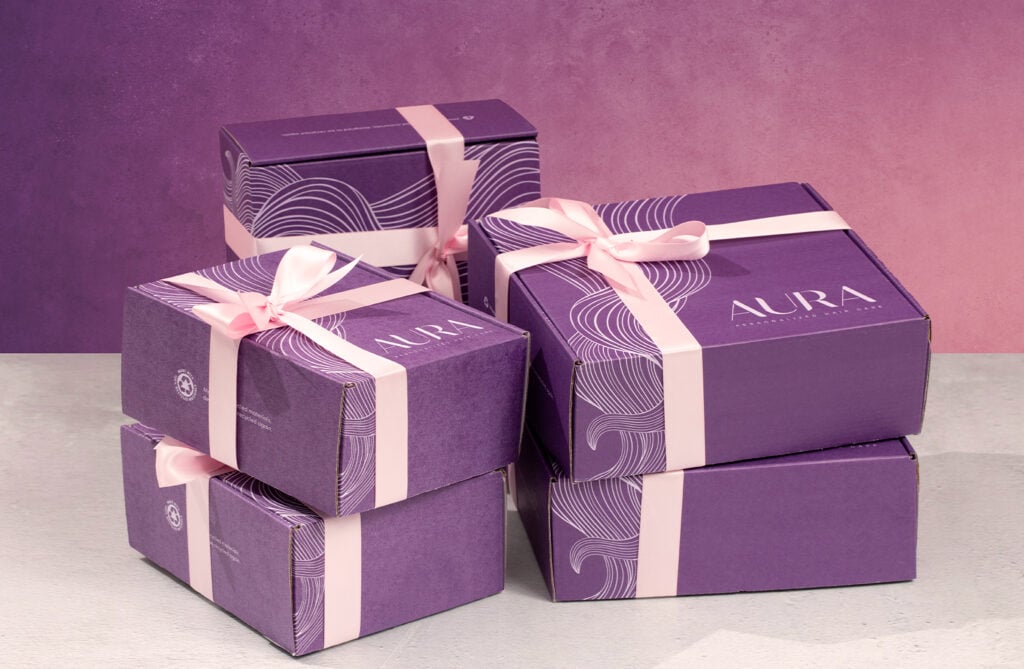 Image of AURA Hair Care boxes wrapped in pink bows and ready to gift!