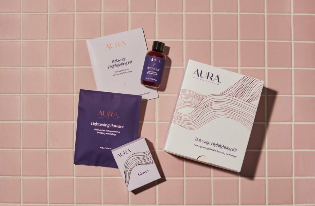 AURA Hair Care Balayage Highlighting Kit unboxed with contents that include Instructions, Lightening Powder, Activator, and Gloves. 