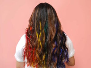 Our social media manager, Leslie, with rainbow hair, featuring our semi-permanent hair color.