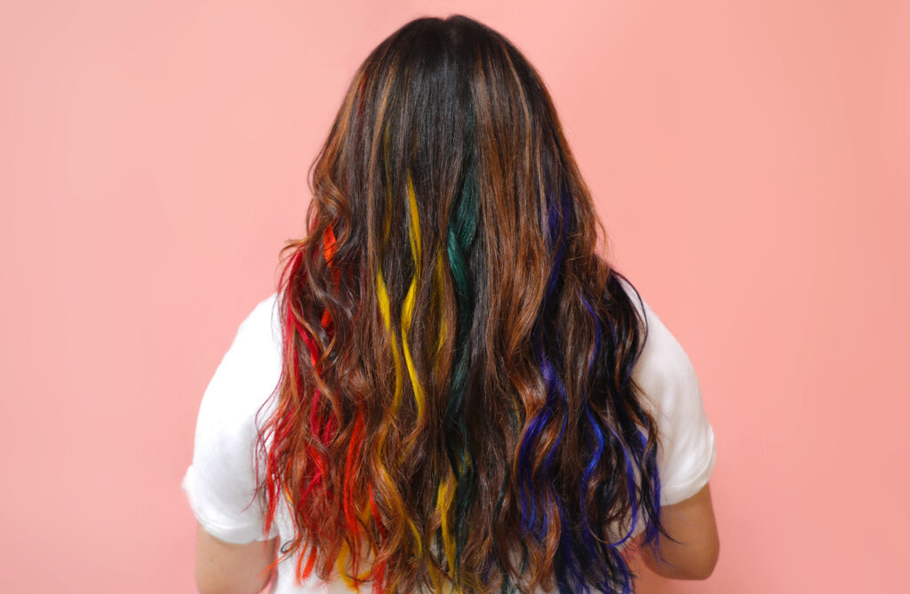 Our social media manager, Leslie, with rainbow hair, featuring our semi-permanent hair color. 