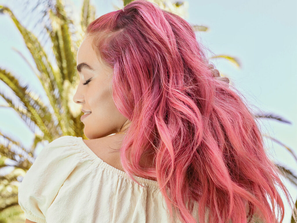 AURA Hair Care model with hair dyed with Miami Pink Pigment. 