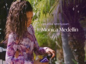 Monica Medellin looking at her AURA hair care products