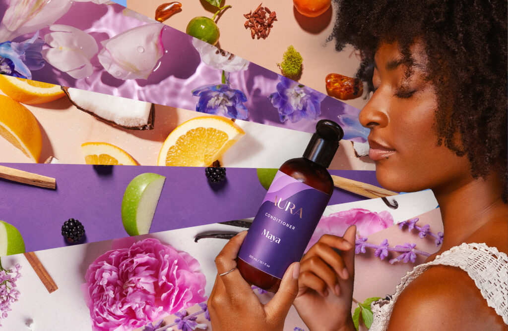 Image of a person smelling their AURA hair care products with a collage of natural elements found in our aromas like oranges and apple slices. 