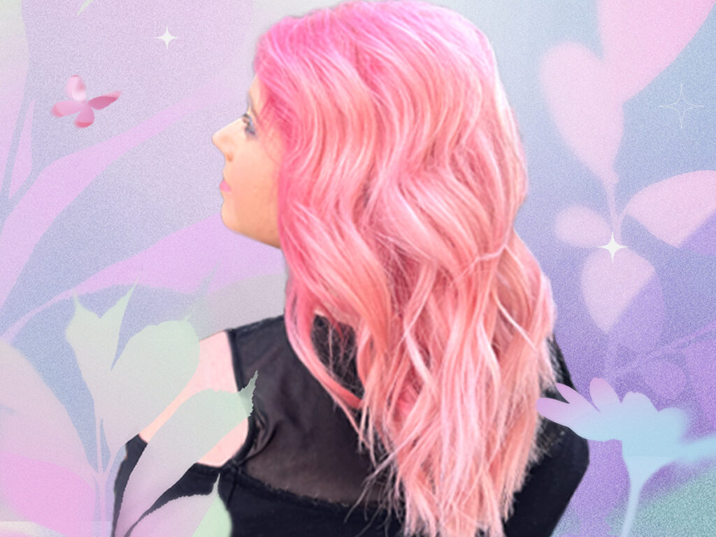 Woman showing a pink hair color on a wavy hair texture
