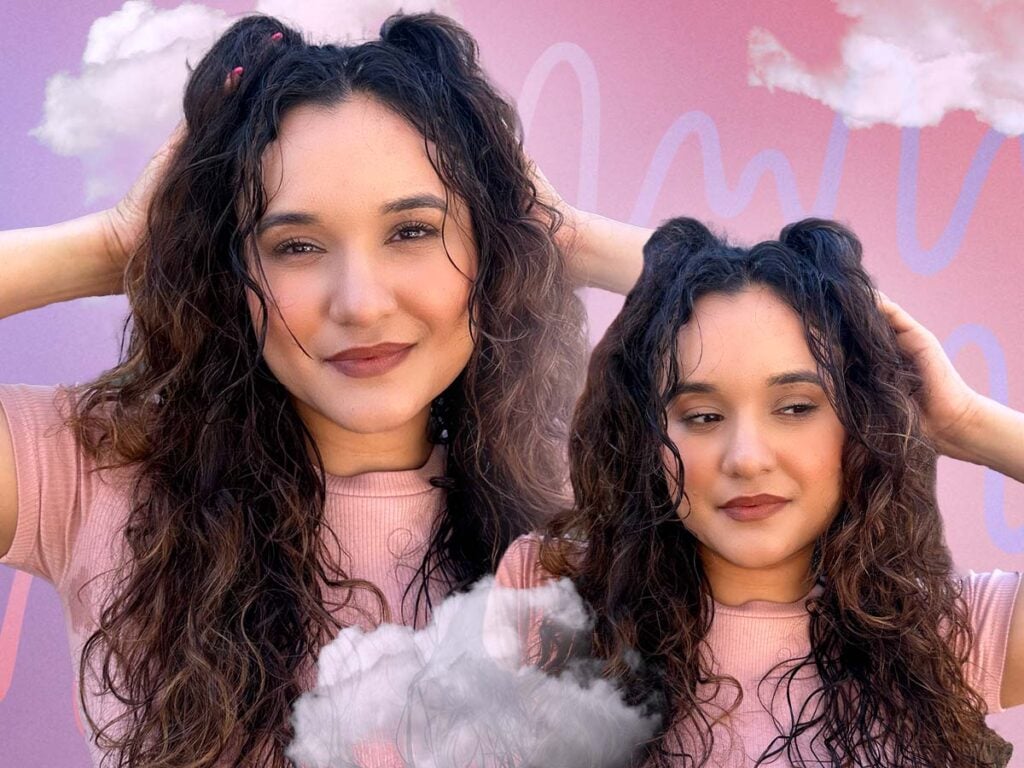 Woman with curly hair showing off a half-up, half-down pigtail hairstyle. 