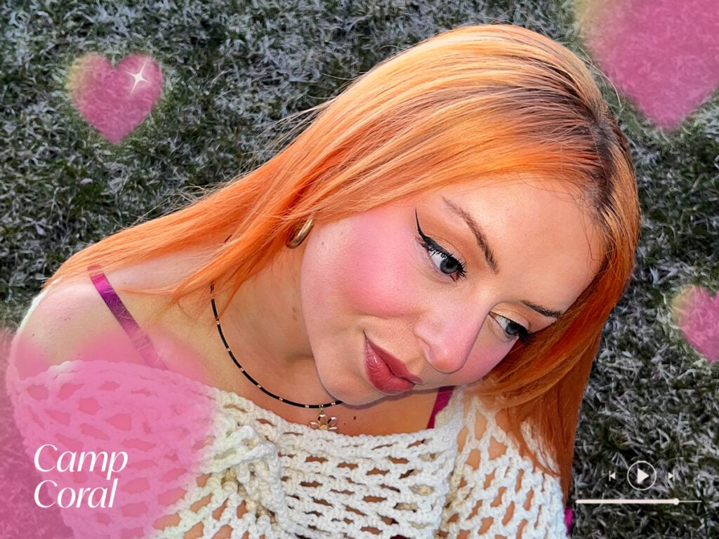 Person showing off a coral hair color