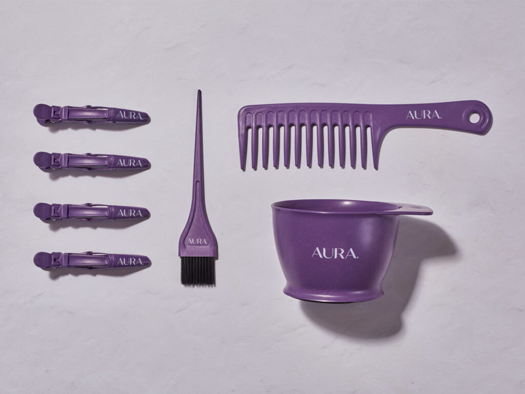 AURA's professional hair tools including hair clips, application brush, bowl, and comb in purple displayed on a plain background.