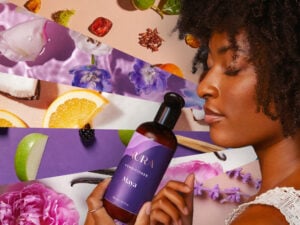 Woman smelling her AURA hair care product with a collage of elements featured in our aromas in the background.